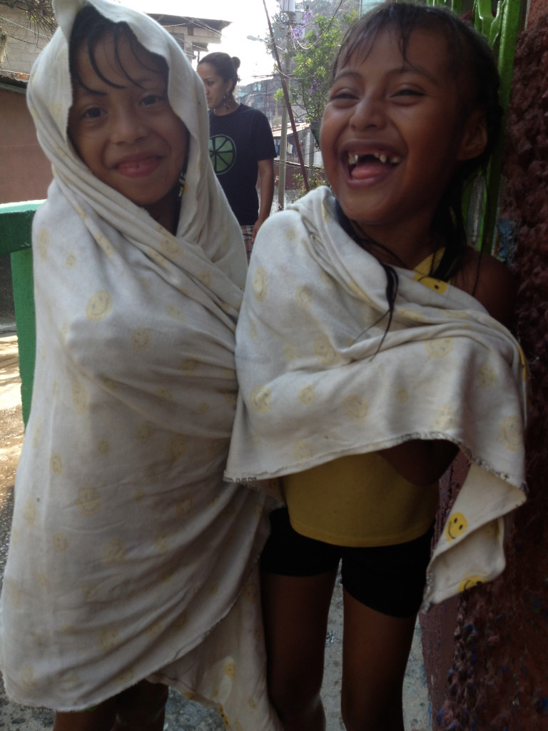 Shirley and Rosita dry off after playing with water at the Limon Academy