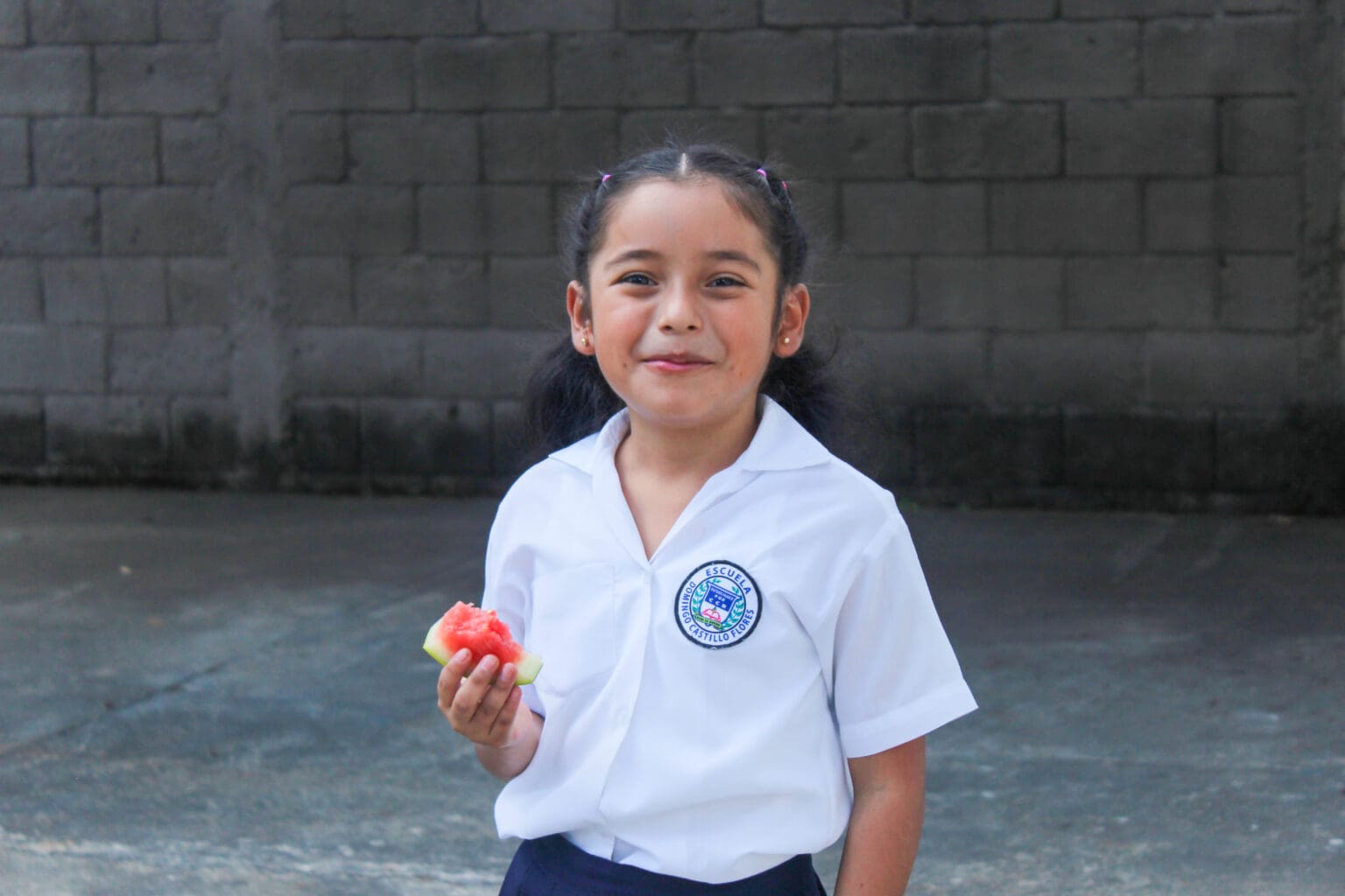 Girl in a school uniform smiling